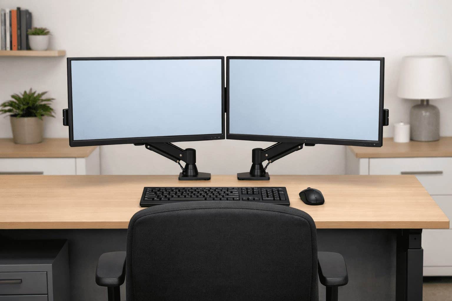 Ergonomic dual monitor setup with screens angled inward, eye-level bezels, centered keyboard, aligned chair, and proper distance.