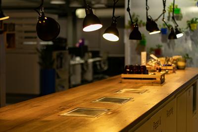 Best smart home devices for beginners, including smart bulbs and plugs, rest on a wooden table in close-up.