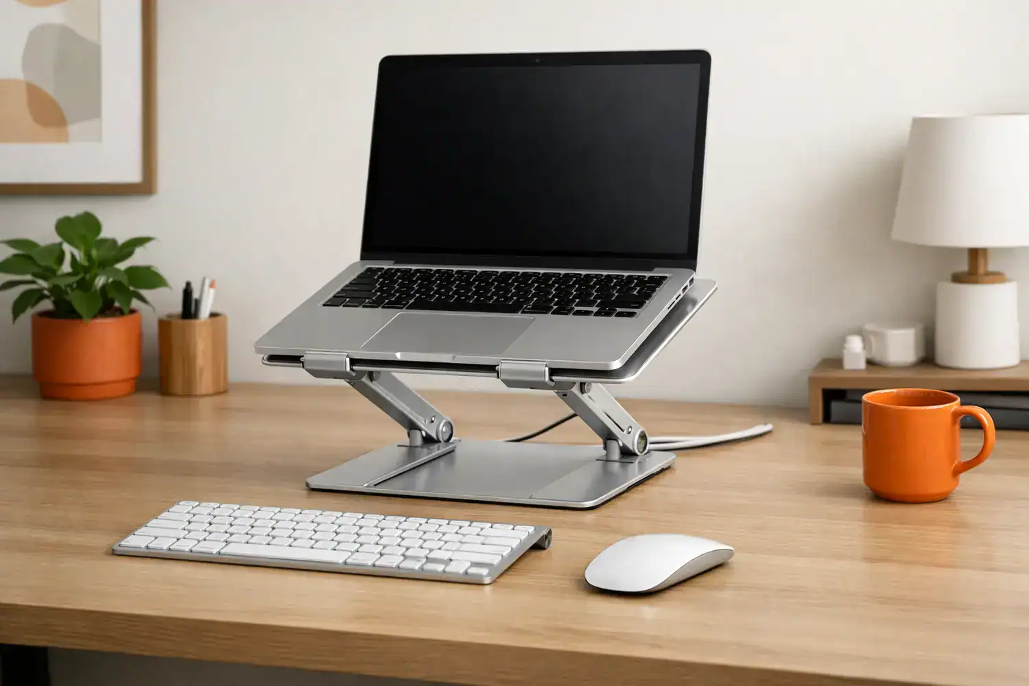 Modern desk with laptop on an aluminum stand, showing one of the best laptop stands for desk setup.